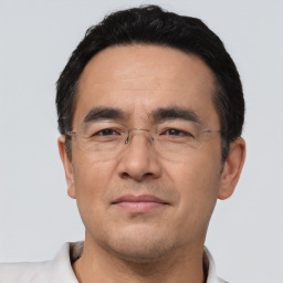 Joyful asian adult male with short  black hair and brown eyes