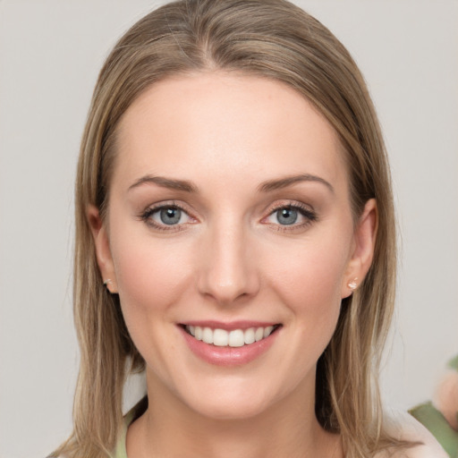 Joyful white young-adult female with medium  brown hair and grey eyes