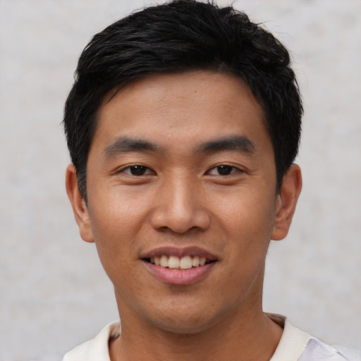 Joyful asian young-adult male with short  black hair and brown eyes