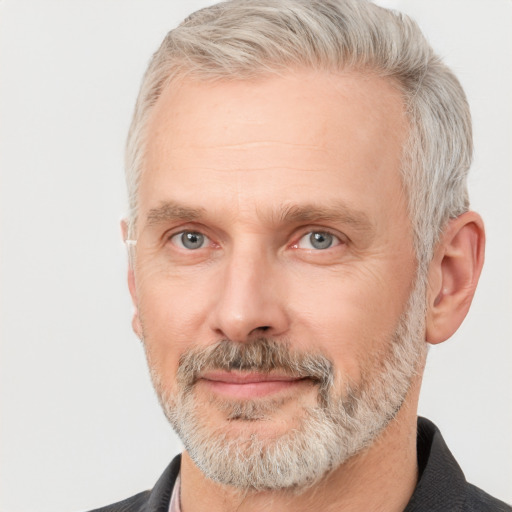 Joyful white middle-aged male with short  gray hair and grey eyes