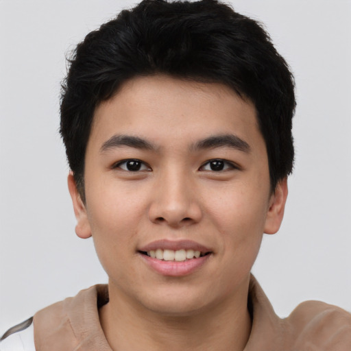 Joyful asian young-adult male with short  black hair and brown eyes
