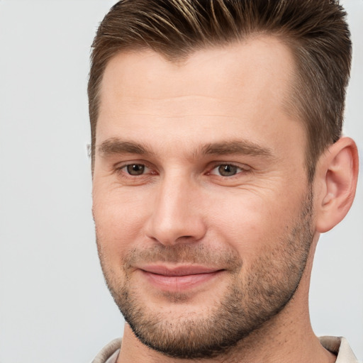 Joyful white young-adult male with short  brown hair and brown eyes