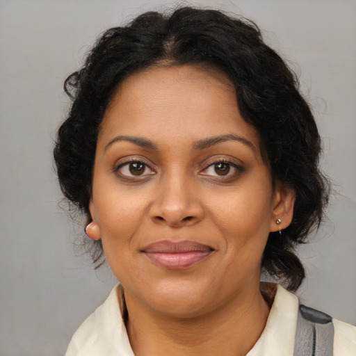 Joyful black young-adult female with medium  brown hair and brown eyes