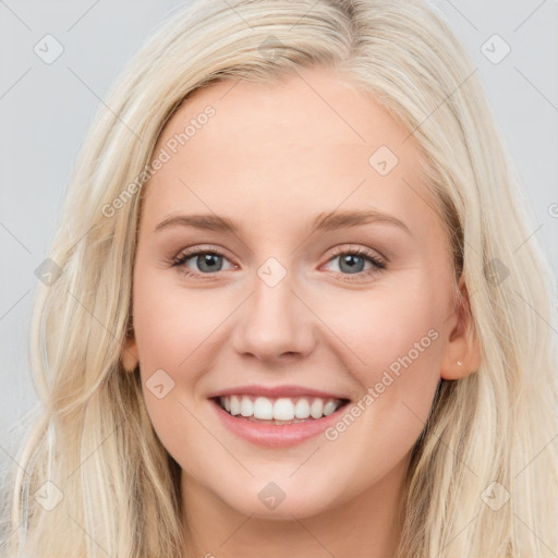 Joyful white young-adult female with long  brown hair and blue eyes