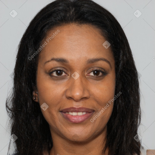 Joyful black adult female with long  brown hair and brown eyes