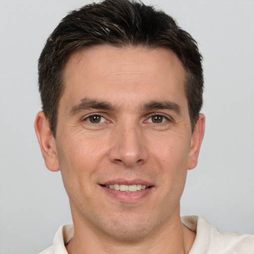 Joyful white adult male with short  brown hair and brown eyes