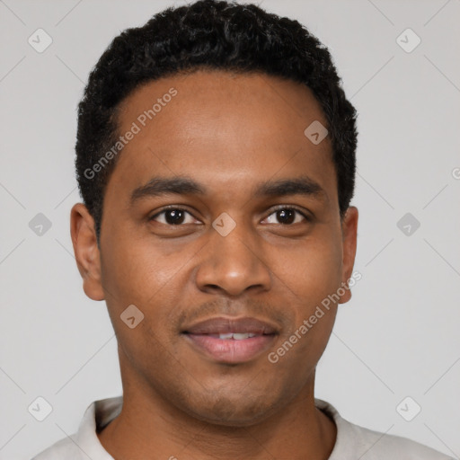 Joyful black young-adult male with short  black hair and brown eyes