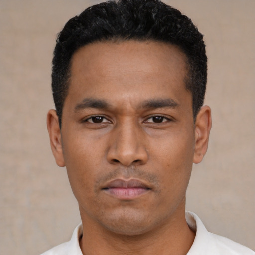 Neutral latino young-adult male with short  black hair and brown eyes