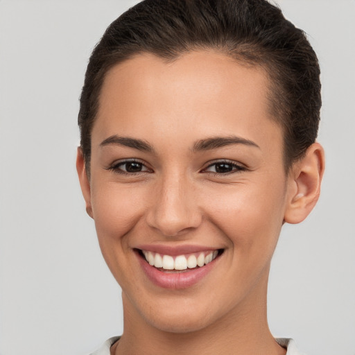 Joyful white young-adult female with short  brown hair and brown eyes