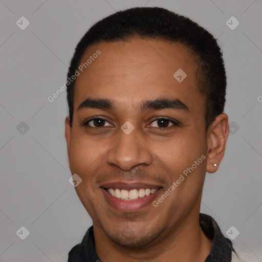 Joyful latino young-adult male with short  black hair and brown eyes