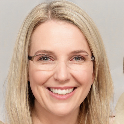 Joyful white adult female with long  brown hair and brown eyes