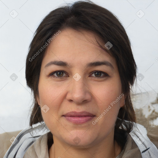 Joyful white adult female with medium  brown hair and brown eyes