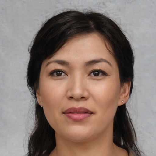 Joyful white young-adult female with medium  black hair and brown eyes