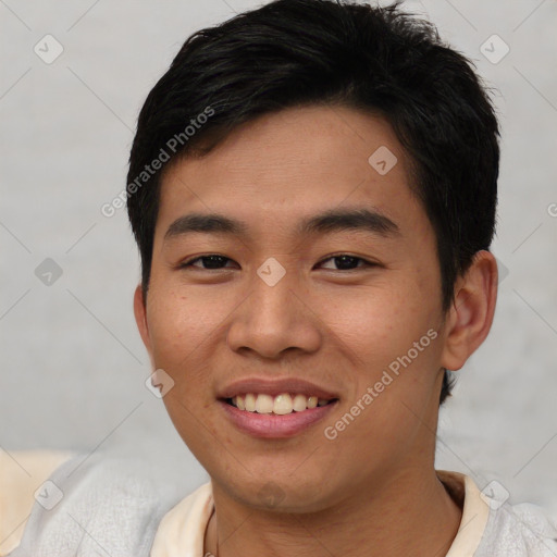 Joyful asian young-adult male with short  black hair and brown eyes