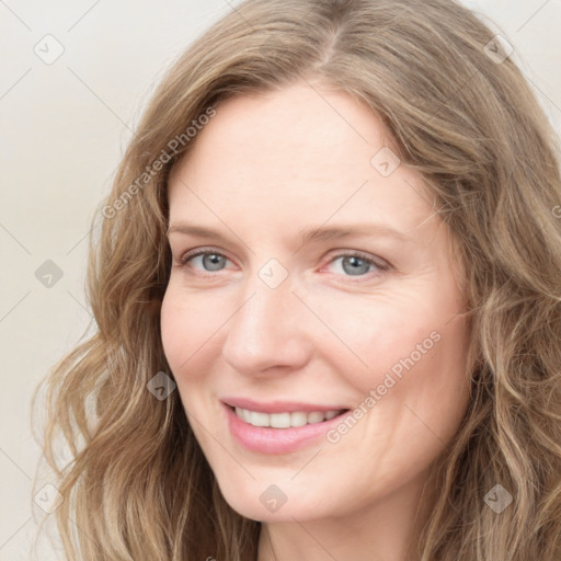 Joyful white young-adult female with long  brown hair and blue eyes