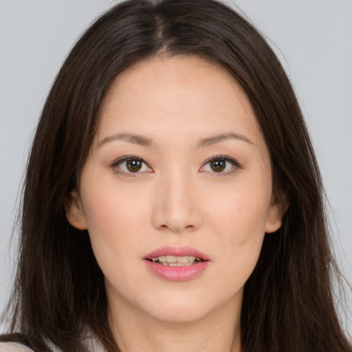 Joyful white young-adult female with long  brown hair and brown eyes