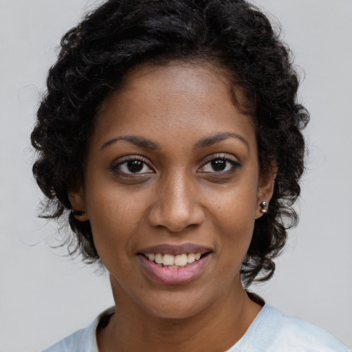 Joyful black young-adult female with short  brown hair and brown eyes