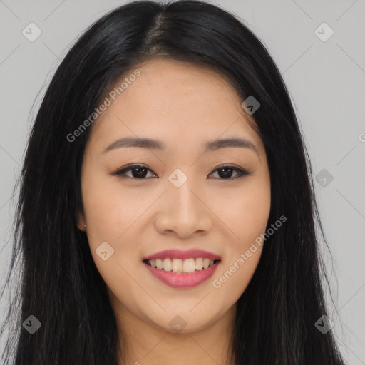 Joyful asian young-adult female with long  black hair and brown eyes