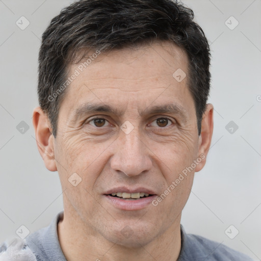 Joyful white adult male with short  brown hair and brown eyes