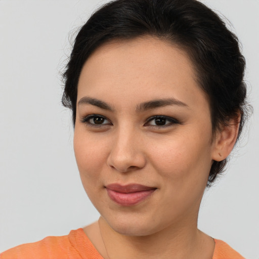 Joyful asian young-adult female with short  brown hair and brown eyes