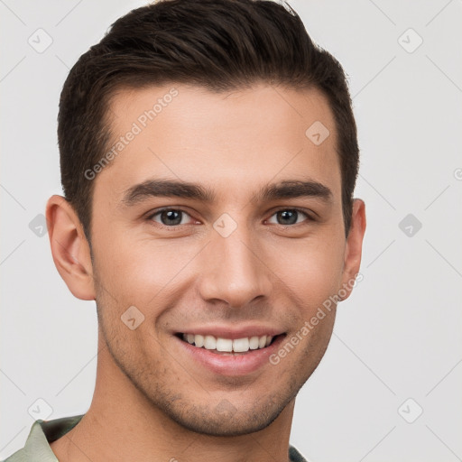 Joyful white young-adult male with short  brown hair and brown eyes