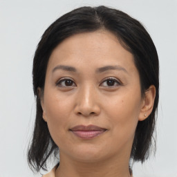 Joyful asian adult female with medium  brown hair and brown eyes