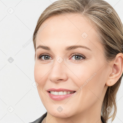 Joyful white young-adult female with long  brown hair and blue eyes