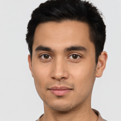 Joyful latino young-adult male with short  brown hair and brown eyes