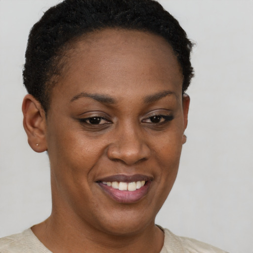 Joyful black young-adult female with short  brown hair and brown eyes