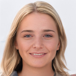 Joyful white young-adult female with long  brown hair and blue eyes