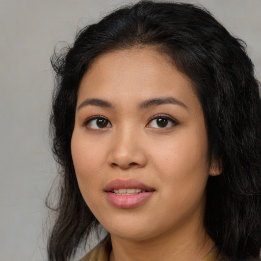 Joyful asian young-adult female with long  black hair and brown eyes