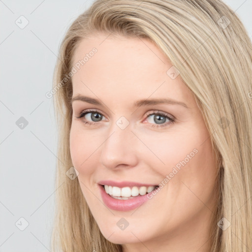 Joyful white young-adult female with long  brown hair and blue eyes