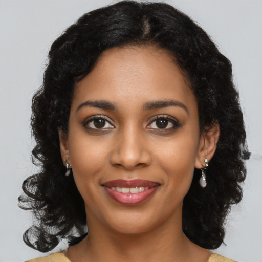 Joyful black young-adult female with medium  black hair and brown eyes