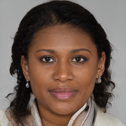 Joyful black young-adult female with medium  brown hair and brown eyes