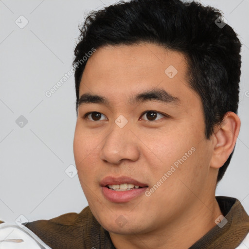 Joyful asian young-adult male with short  brown hair and brown eyes