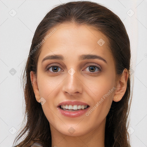 Joyful white young-adult female with long  brown hair and brown eyes