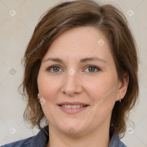 Joyful white adult female with medium  brown hair and grey eyes