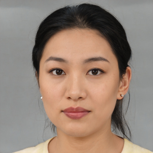 Joyful asian young-adult female with medium  black hair and brown eyes