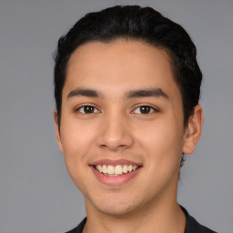 Joyful latino young-adult male with short  black hair and brown eyes