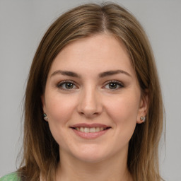 Joyful white young-adult female with medium  brown hair and green eyes