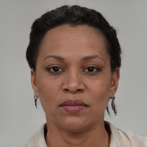 Joyful black adult female with short  brown hair and brown eyes