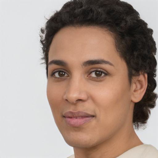 Joyful latino young-adult female with short  brown hair and brown eyes