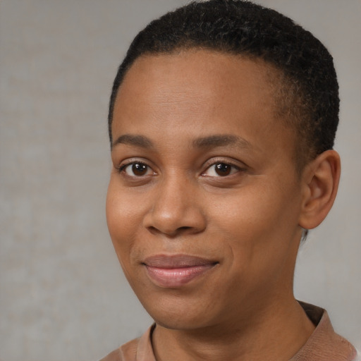 Joyful black young-adult female with short  brown hair and brown eyes