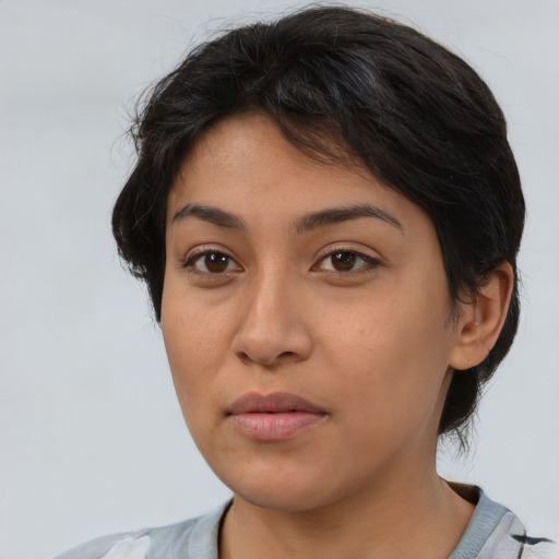 Neutral latino young-adult female with medium  brown hair and brown eyes