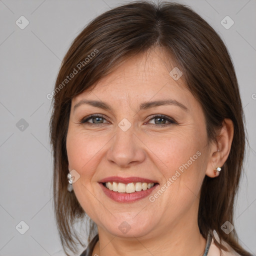 Joyful white adult female with medium  brown hair and brown eyes