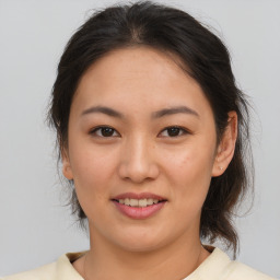 Joyful white young-adult female with medium  brown hair and brown eyes