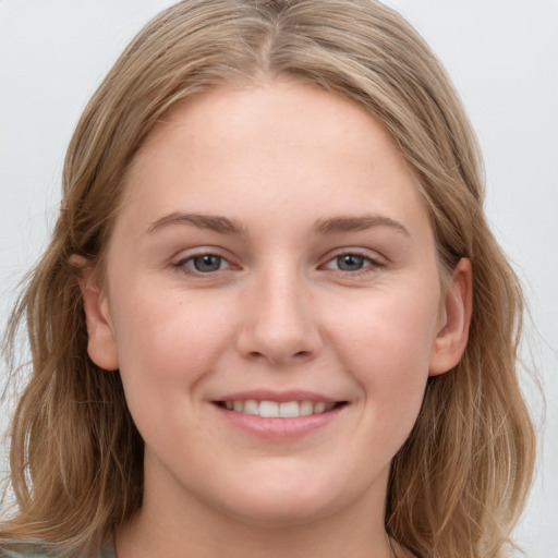 Joyful white young-adult female with long  brown hair and grey eyes