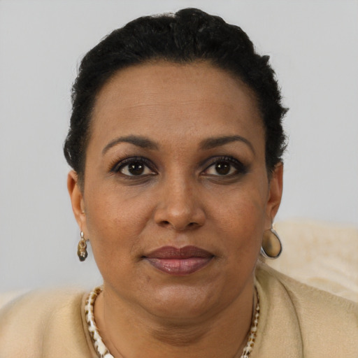 Joyful black adult female with short  brown hair and brown eyes