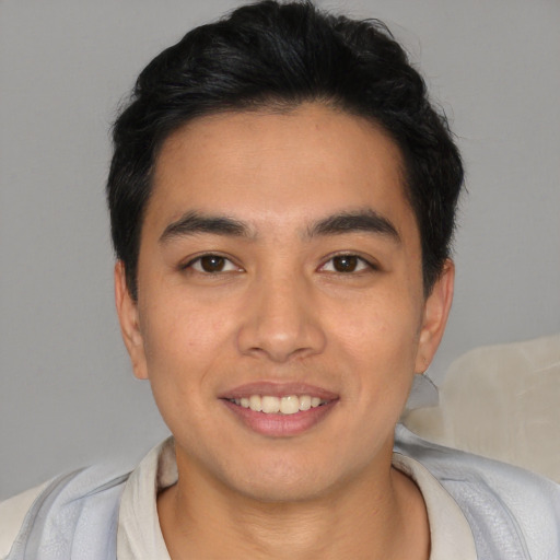 Joyful asian young-adult male with short  black hair and brown eyes