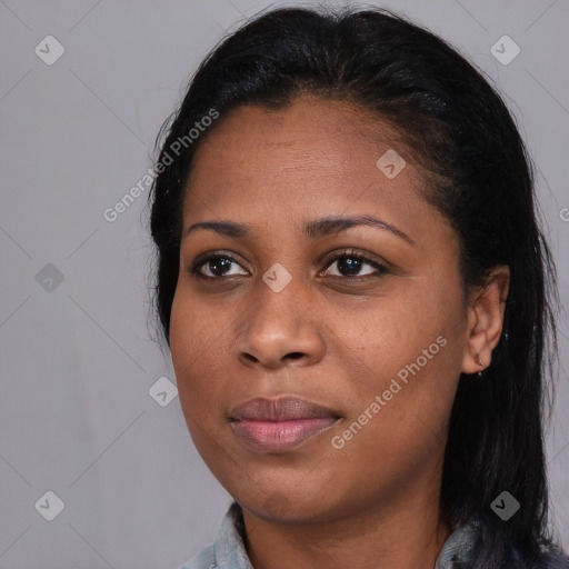 Joyful black young-adult female with long  black hair and brown eyes